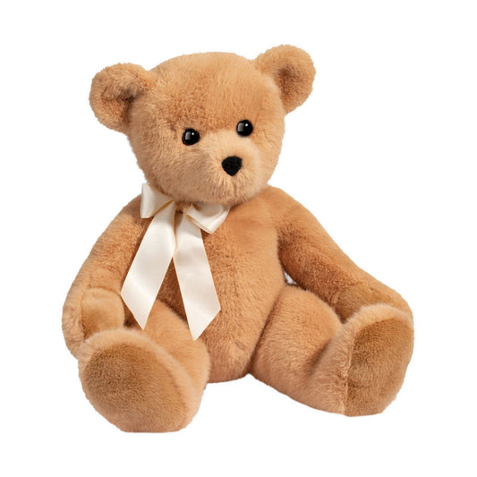 Det här är Graham, en nalle från Douglas Cuddle Toys. Han sitter och har kort, tät beige päls med lätt glans. Nosen är något ljusare beige, öronens insida matchar pälsen, och mage och tassar är beige utan synliga trampdynor. Ögonen är svarta och runda, nosen är liten och svart med rundad triangelform. Inga tydliga markeringar finns. Runt halsen sitter ett gräddvitt satinband knutet i rosett. Kroppen är sittande utan rörliga leder och ansiktet har en mild, lugn uppsyn.