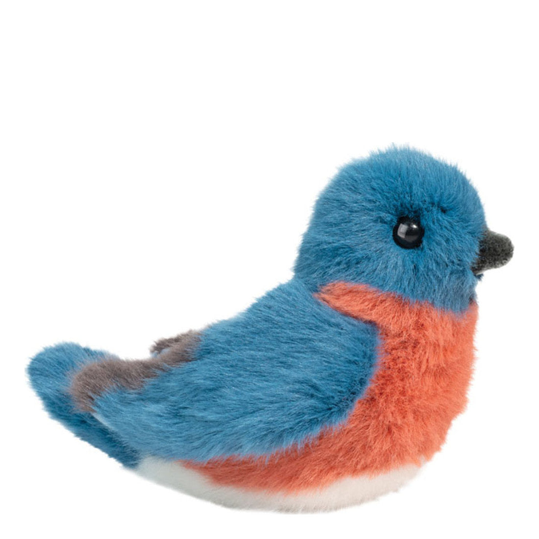 This is Bertie Bluebird by Douglas Cuddle Toys. Small sitting bird with long, fluffy, soft-looking fur that has a low sheen and appears very soft to the touch. Fur colours are blue on the head, back and wings, orange on the breast and sides, white on the lower belly, and small gray accents on the tail and beak. The head is rounded with a short gray beak. One round black eye is visible on the side of the head. Wings are folded against the body and a short tail projects at the rear. The plush sits in a s...