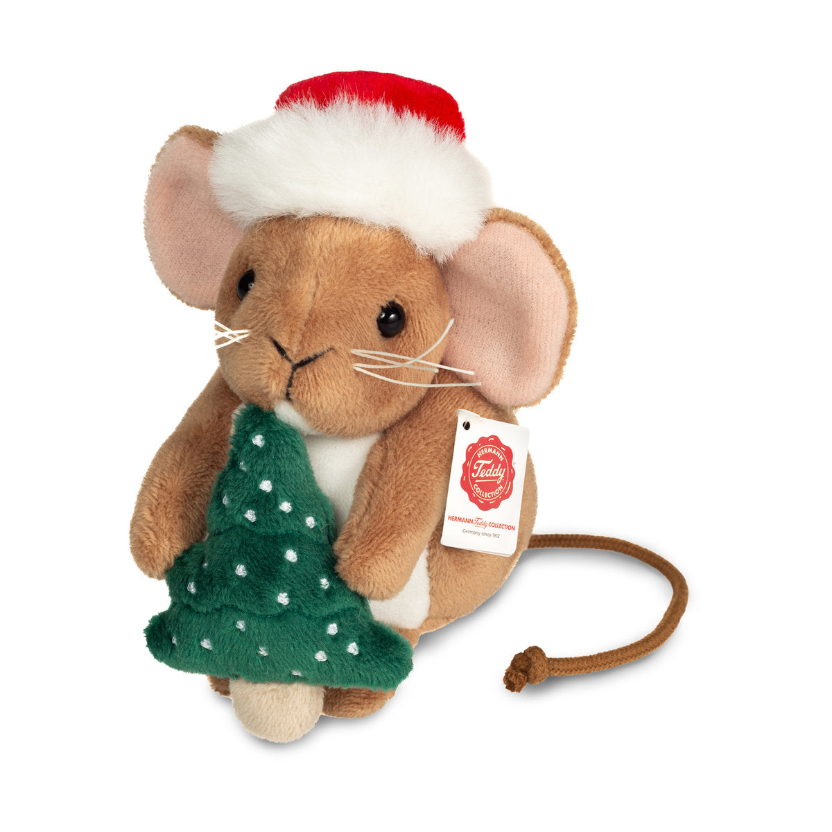 Det här är en julmus från Teddy-Hermann. Liten sittande mus med kort, tät, lätt blank beige päls, vit mage och en vit fläck på bröstet. Nosen är beige, öronens insida ljusrosa och tassarna beige med trampdynor i pälsens färg. Ögonen är svarta och runda, nosspetsen liten och svart med tydliga gräddvita morrhår. En lång, tunn brun svans sticker ut baktill. Musen bär en röd tomteluva med vit fluffig kant och håller en liten grön julgran med vita prickar. Uttrycket är lugnt och nöjt.