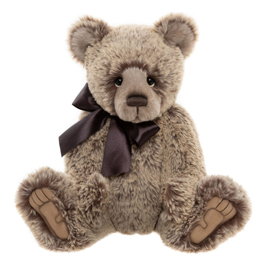 This is Davey by Charlie Bears. Sitting fully jointed teddy with medium-length, slightly waved fur that has a soft sheen. The fur is predominantly beige with darker brown spotting and brown highlights around the eyes; the fur appears dense and plush. The muzzle is a lighter beige, the inner ears are beige with brown edges, the tummy and main body fur are beige with brown speckling, and the paws have beige fur with tan brown paw pads visible. Eyes are black and round; the nose is brown and oval with a s...