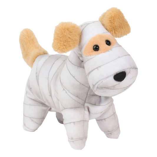 Tämä on Douglas Cuddle Toysin muumiokoira. Pieni koira seisoo, ja hänen turkkinsa on lyhyt, sileä ja tiheä, pinnassa kevyt kiilto. Valkoista turkkia kiertävät harmaat, siteitä muistuttavat raidat päässä, vartalossa ja jaloissa. Korvat, häntä ja silmien seudun kuonolaikku ovat beiget ja samaa lyhyttä, pörröistä pintaa. Masu ja tassut ovat valkoiset, ja niissä on samat harmaat raidat. Silmät ovat mustat ja pyöreät, nenä musta ja soikea. Ilme on ystävällinen ja utelias.
